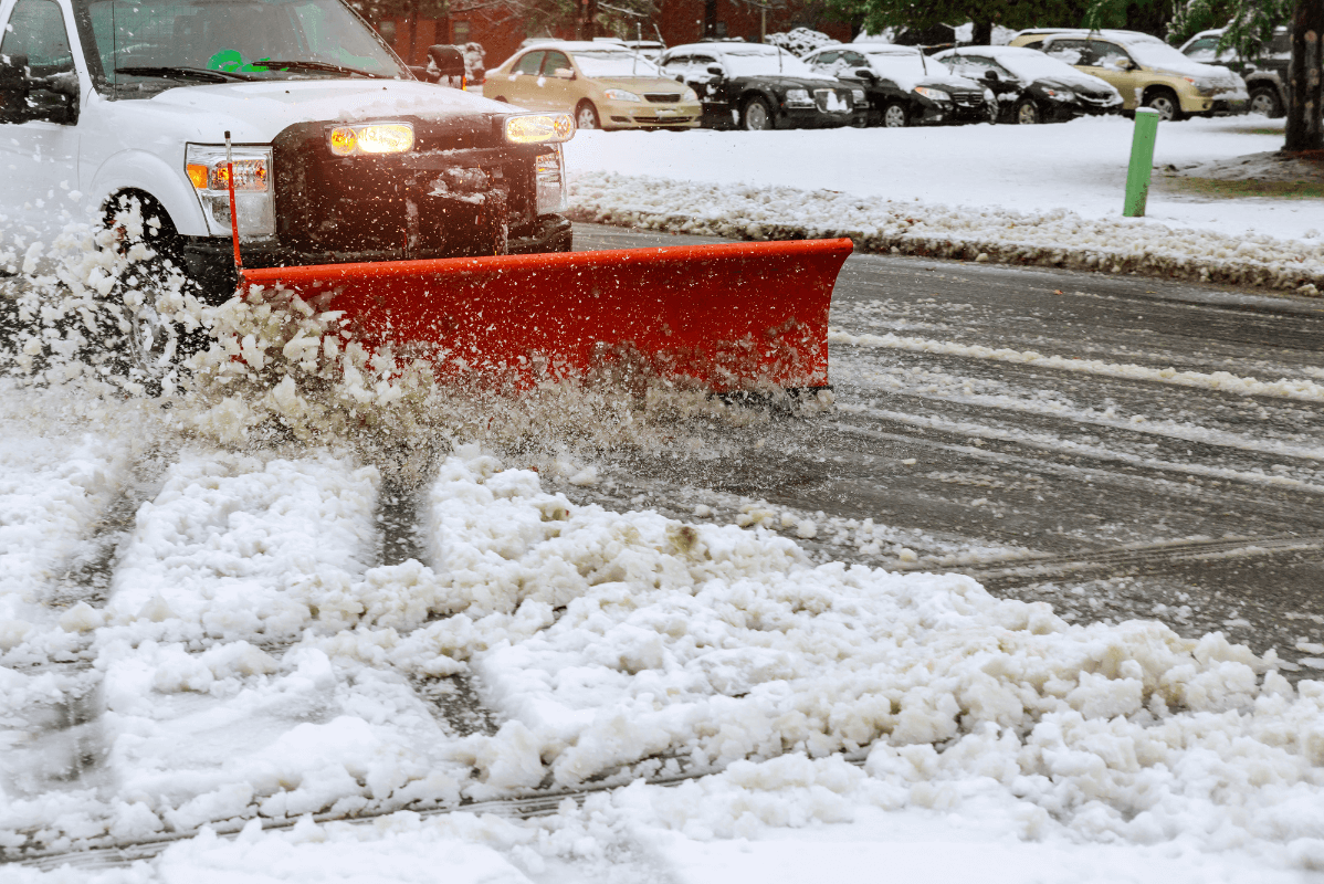 A truck plowing snow in an intersection