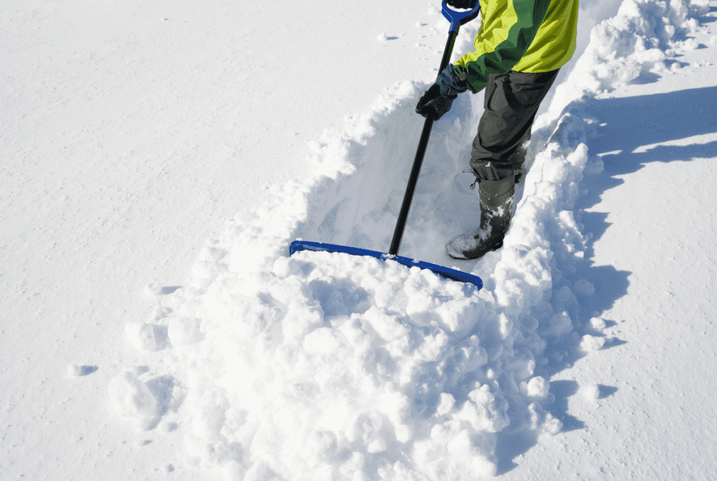 A man shoveling through a thick snowfall
