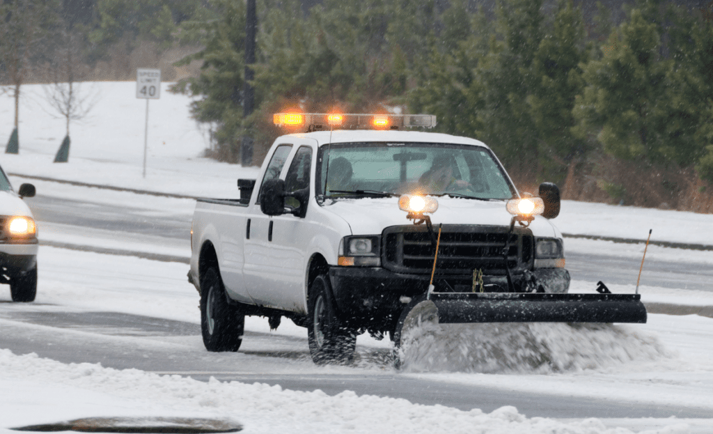 A highway being cleared by a snow plow.