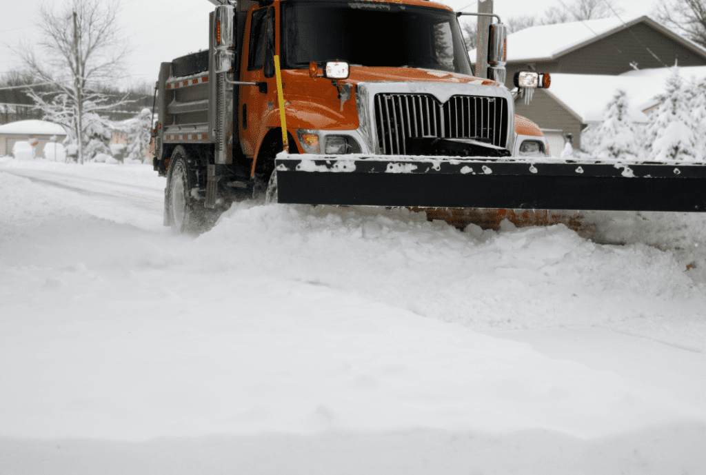 A snow plow truck clearing the streets