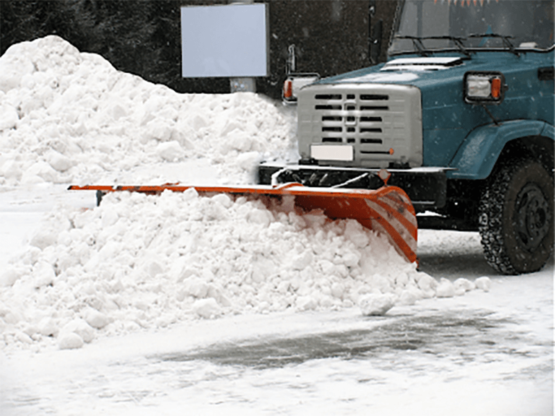 A plow truck cleaning out snow in the streets