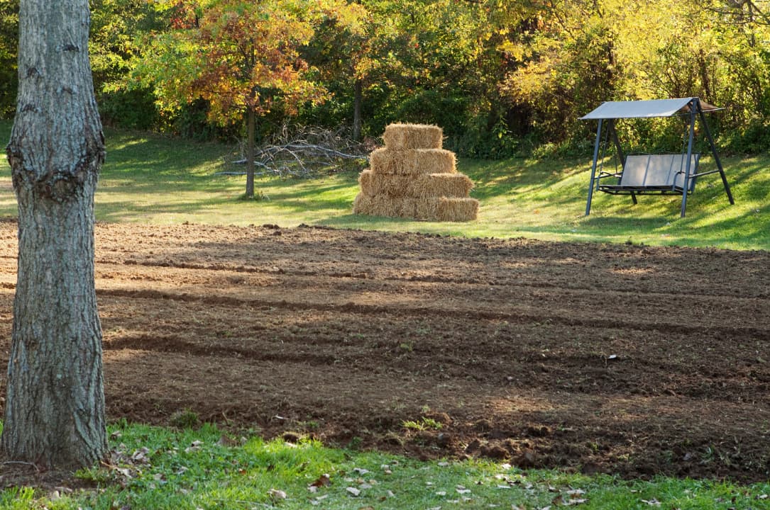 A backyard being graded after the drain installation