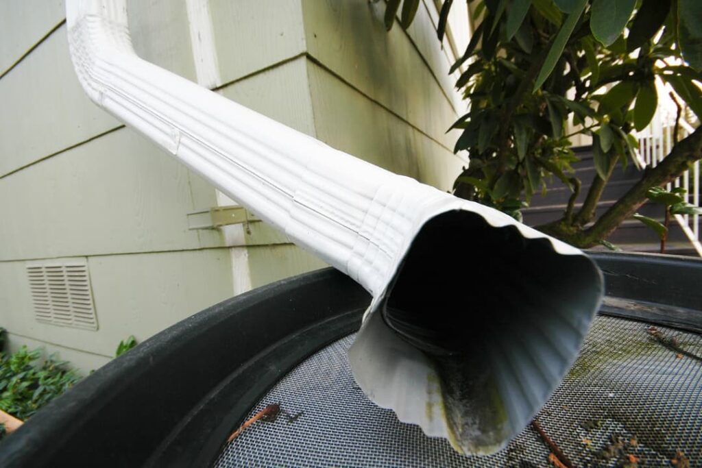 A white downspout installed 