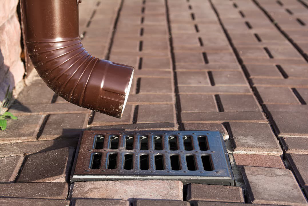 Corner of a house with a drain pipe downspout