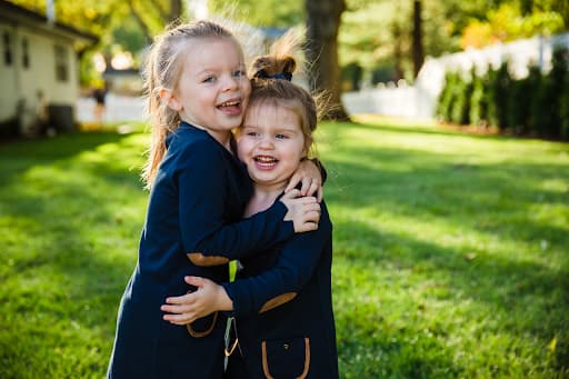 Two happy young girls hugging