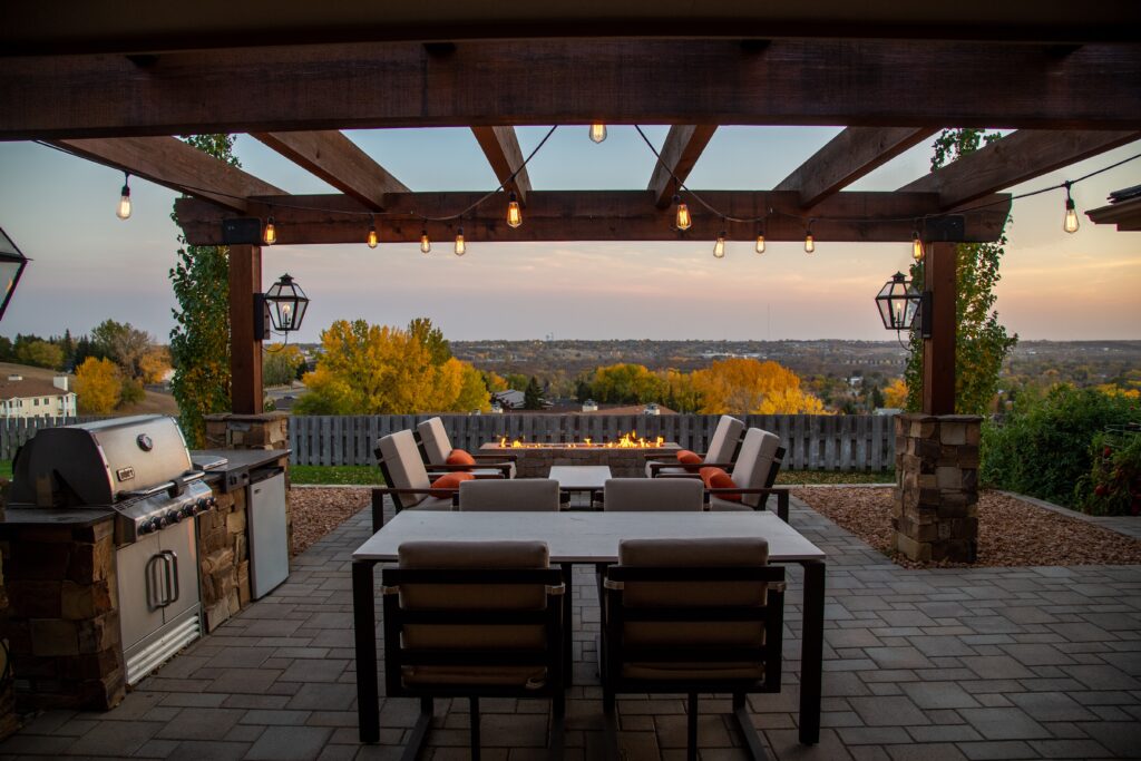 A scenic view looking over an outdoor kitchen and dining area