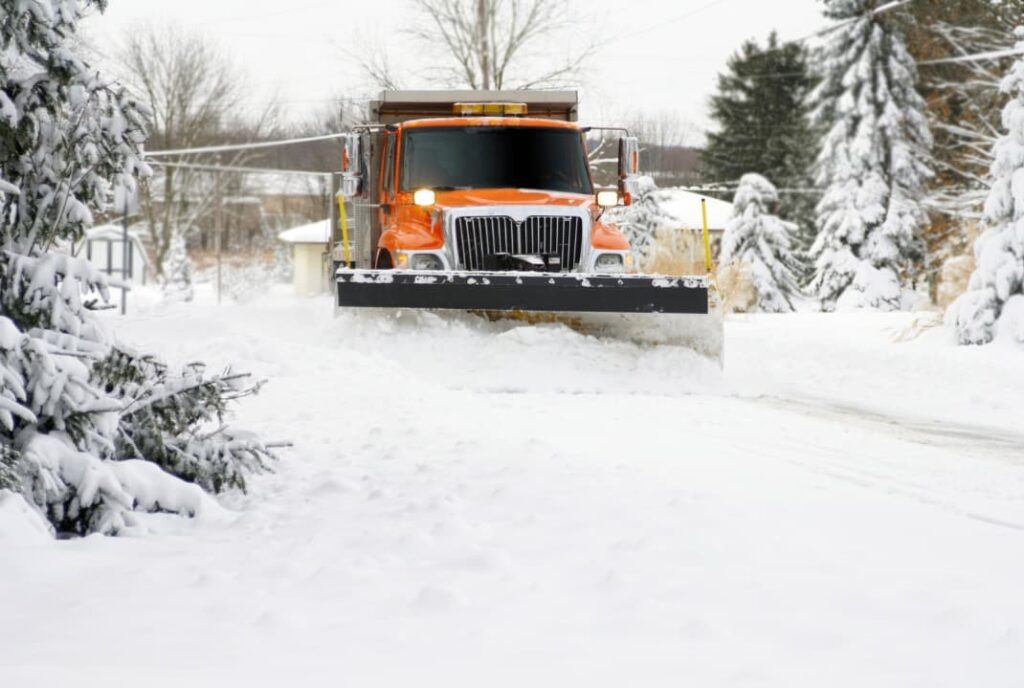 A snow plow approaching during winter in Naperville