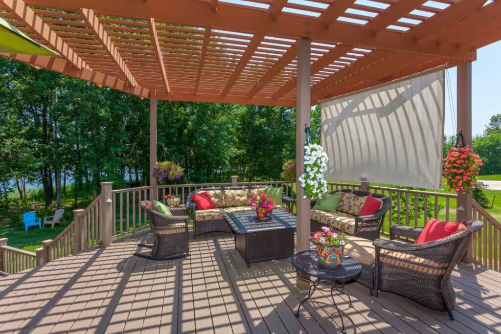 Backyard deck with chairs and pergola on a sunny summer days