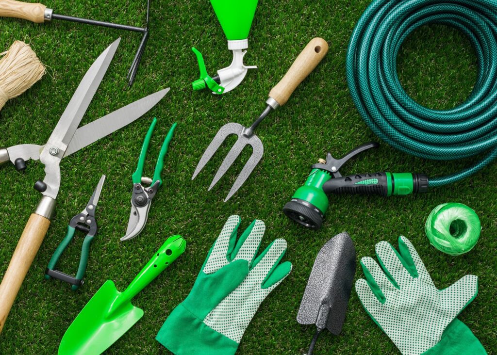 Gardening tools and utensils on a lush green lawn