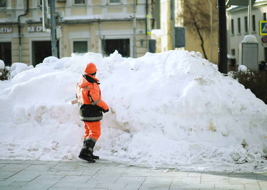 Snow Shoveling and De-icing: Workers may manually shovel snow from sidewalks and pathways, and apply de-icing agents like salt or sand to prevent ice formation.