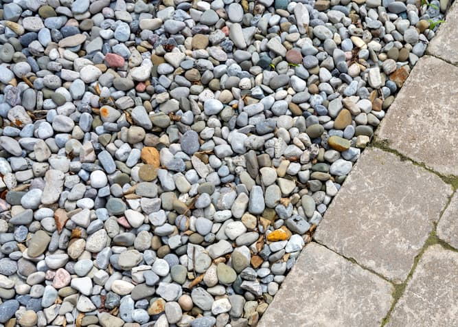 Gravel options for landscaping and drainage, showing stones in different shapes and sizes for water management.