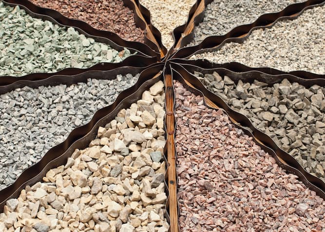 Natural gravel and rocks of different sizes, showcasing their use for efficient water drainage around a home.