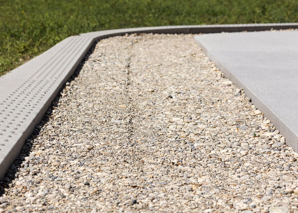 An outdoor area with various gravel types, designed to manage excess water around a home’s foundation.