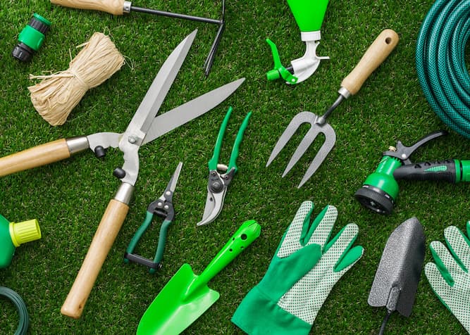 A collection of gardening tools and fertilizer products, demonstrating the essential materials for garden maintenance.