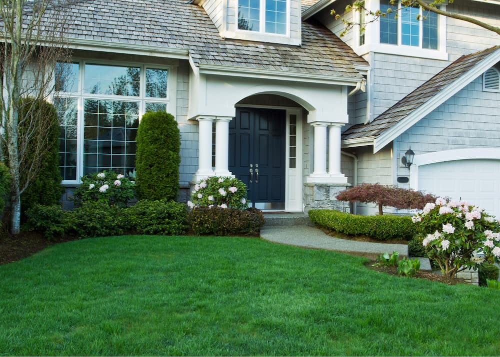 A Crystal Lake lawn with re-edged flowerbeds, clean lawn areas, and freshly trimmed plants, demonstrating comprehensive spring and fall care.
