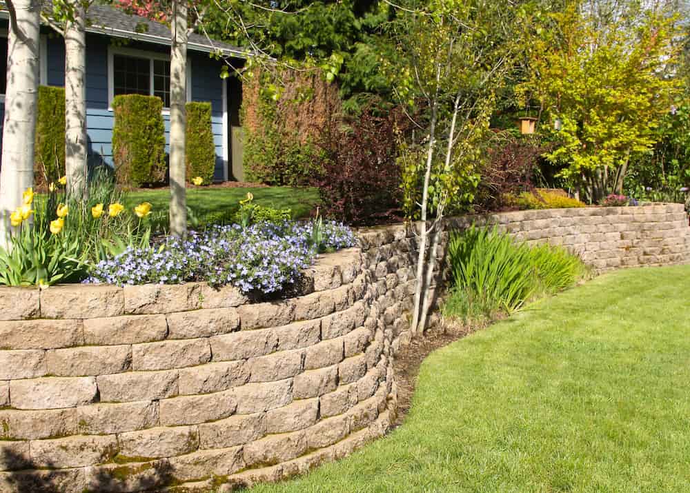 Elegant retaining walls add structure and style to a well-manicured outdoor space.