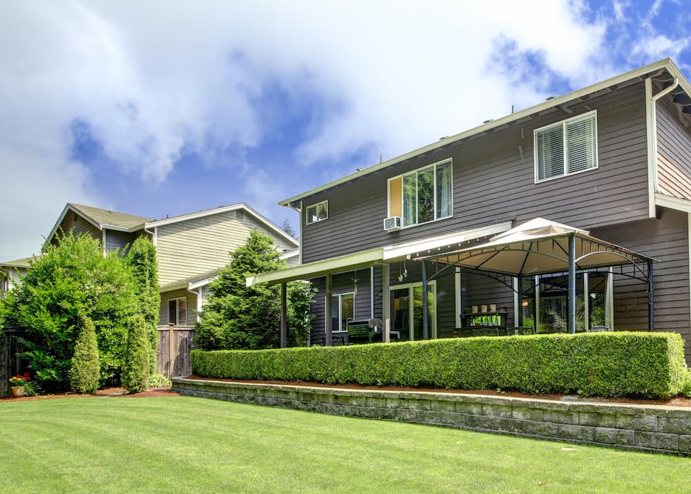 Beautifully landscaped front yard in Wilmette featuring trimmed hedges and flower beds.