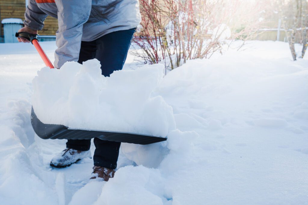 Snow removal. clearing snow by shovel