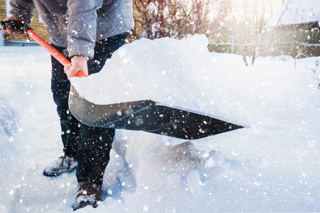 Snow removal. clearing snow by shovel after snowfall.