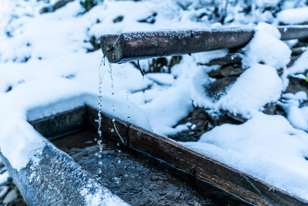 Small water snow drain in winter